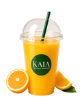 Orange juice in a KAIA cup with a straw, surrounded by orange slices.