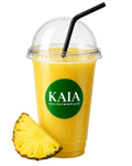 Yellow pineapple juice in a clear cup with a black straw and pineapple slice, featuring the KAIA brand.